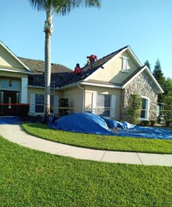 two roofers working on a house